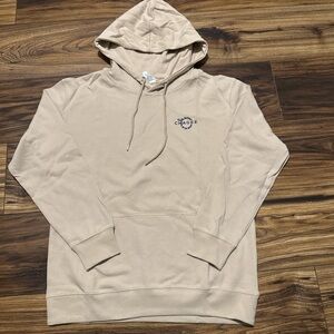 The sweatshirt is beige with dark blue print in the back